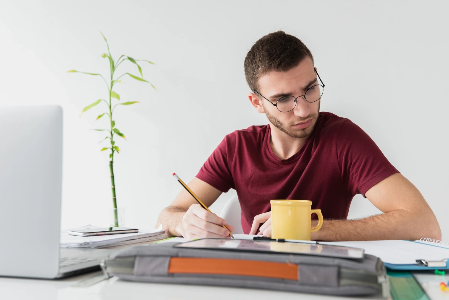 Man with glasses focused on reading